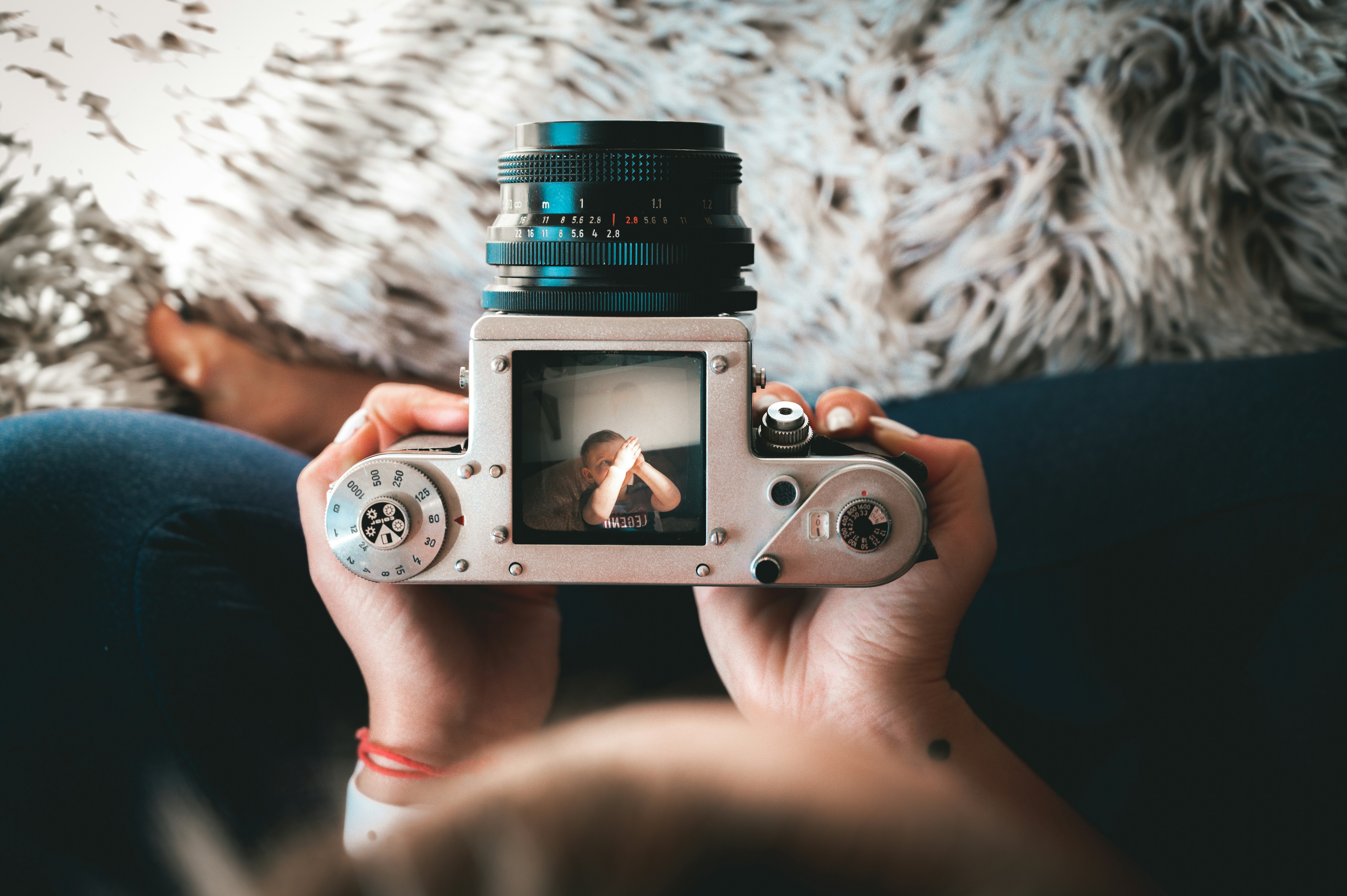 Hands holding a Pentacon Six TL — the same camera I shoot, photographed by someone else.